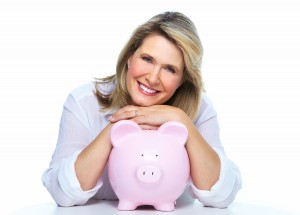 Elderly woman with piggy bank. Isolated over white.